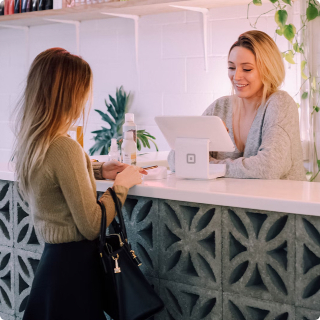 Woman using POS system at a small business