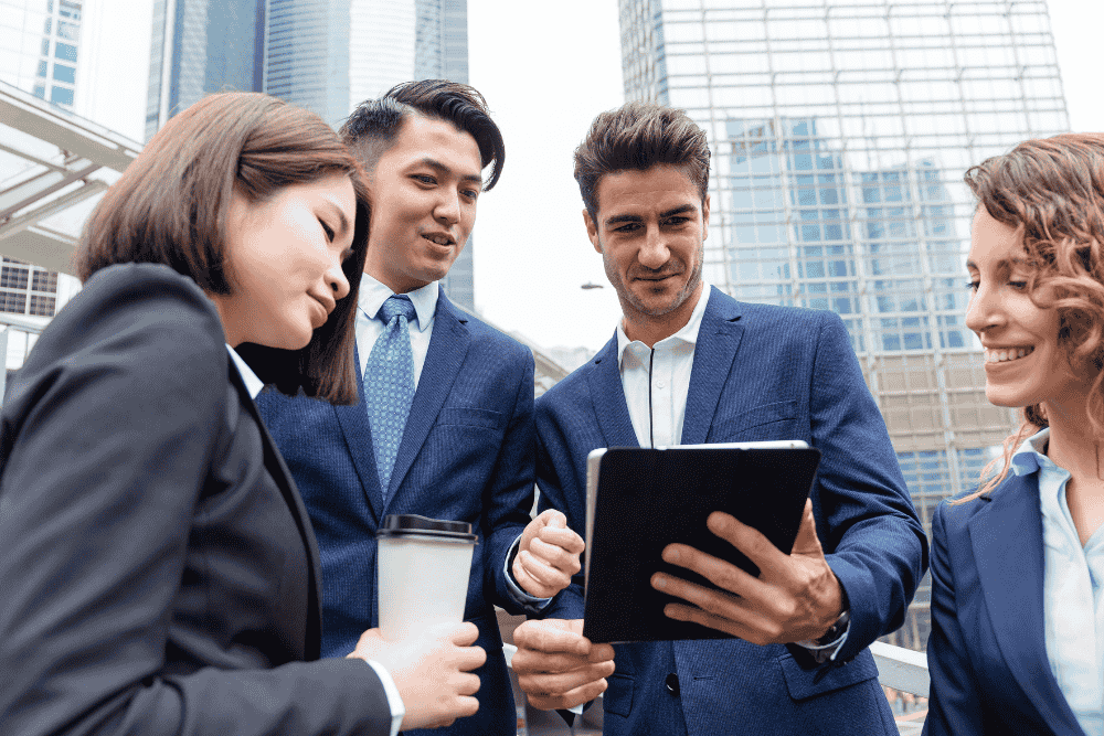Business team collaborating remotely using QuickBooks cloud hosting on multiple devices